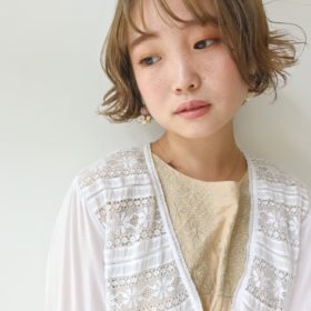 くすんだ栗色の外はねショートボブの女性の写真