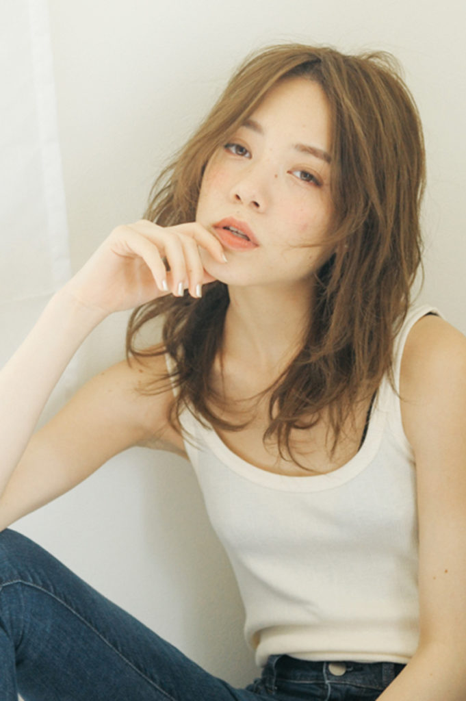 ハイライトを入れた髪をナチュラルに仕上げている女性