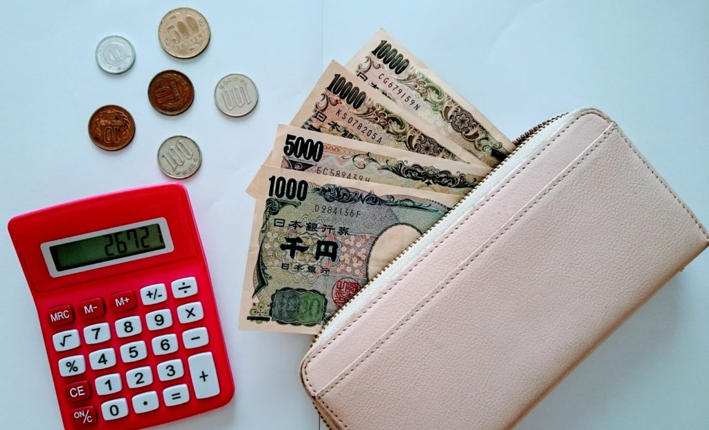 お金と財布と電卓の写真