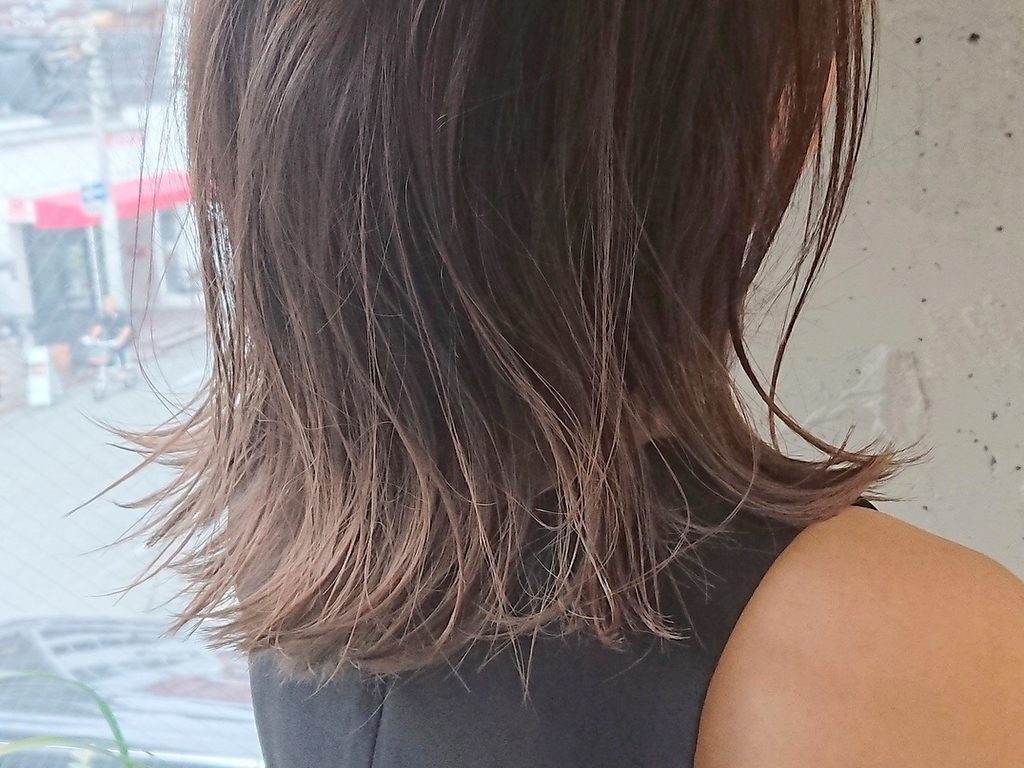 透明感のあるベージュのオンブレカラースタイルの女性の写真